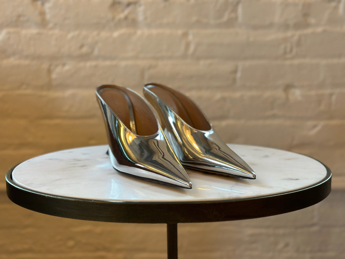 Bottega Veneta Silver Rocket Mules Sitting On Stool