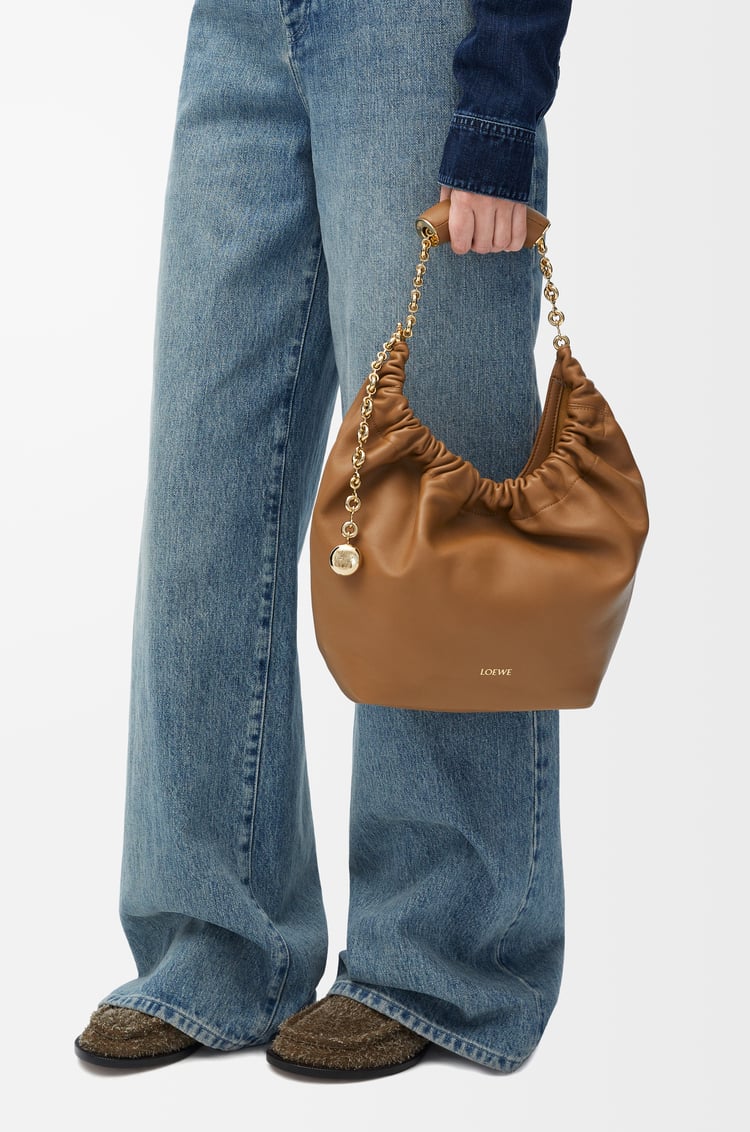 Loewe Squeeze Bag in Small Tan Oak Leather with Gold Hardware Model Holding Top Handle
