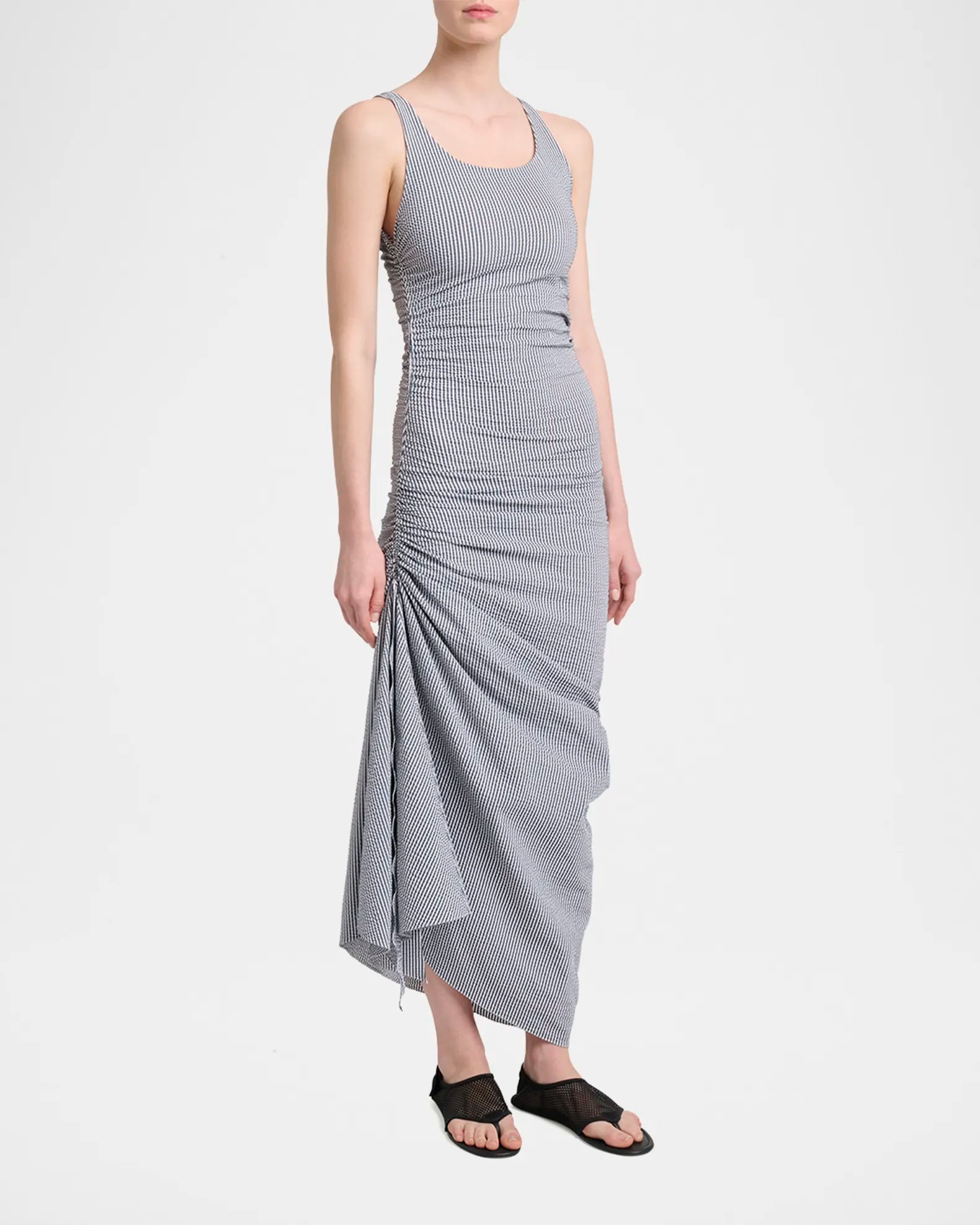 Model wearing Alaia black mesh thong flat sandals full body shot