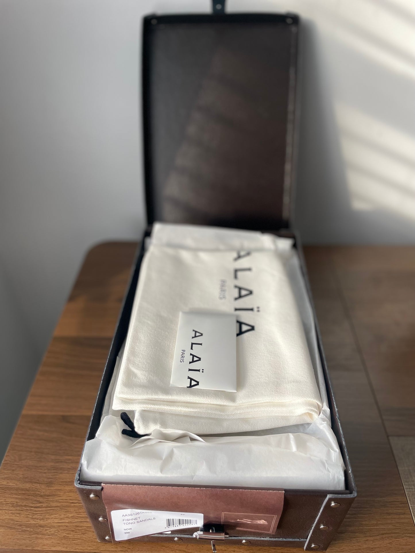 Alaia black mesh thong flat sandals packaging in box