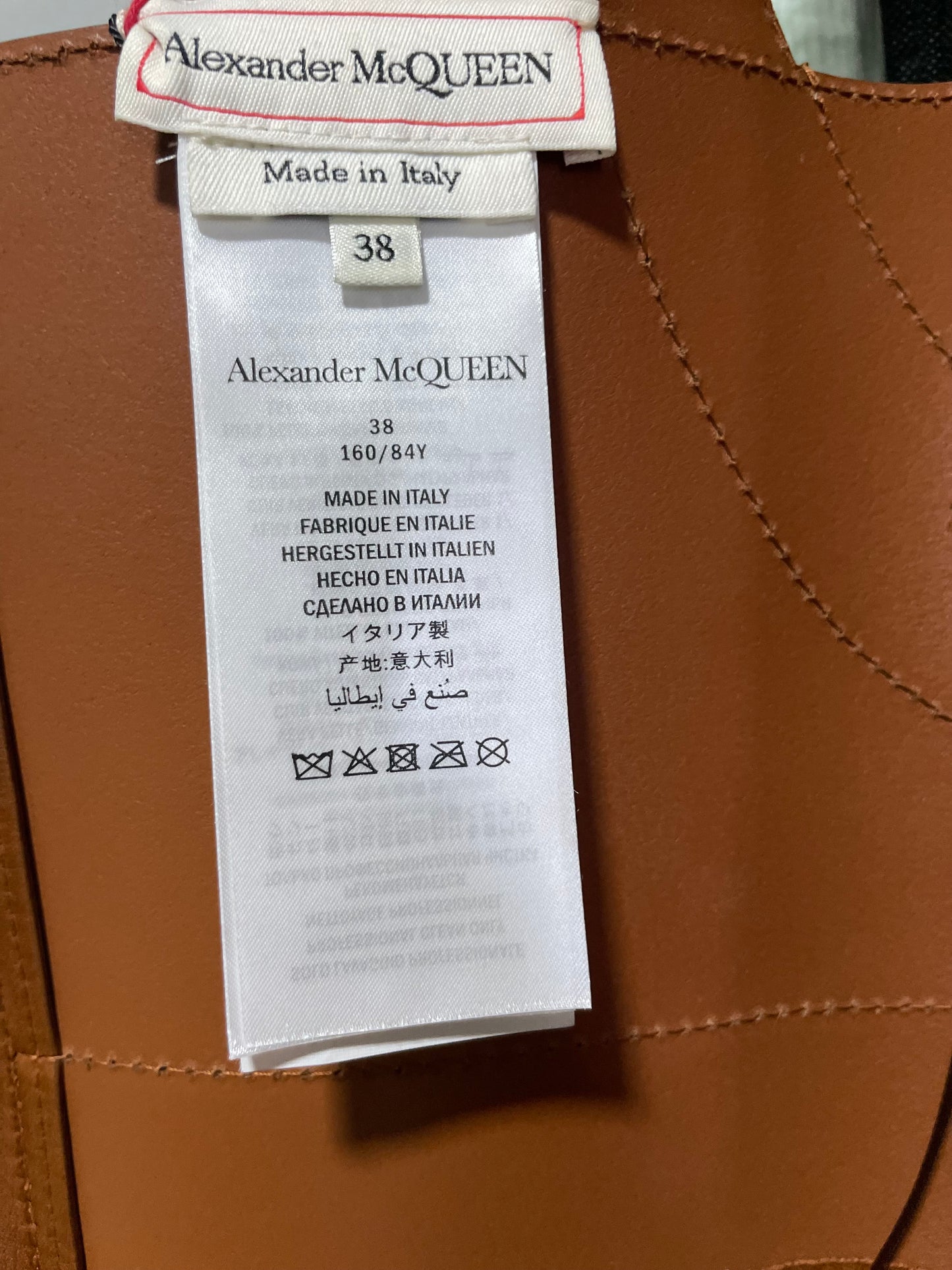 Alexander McQueen clothing label on brown leather corset halter dress