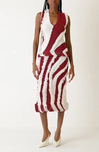 Full body view of model wearing Diotima red & white roaring knit skirt set.