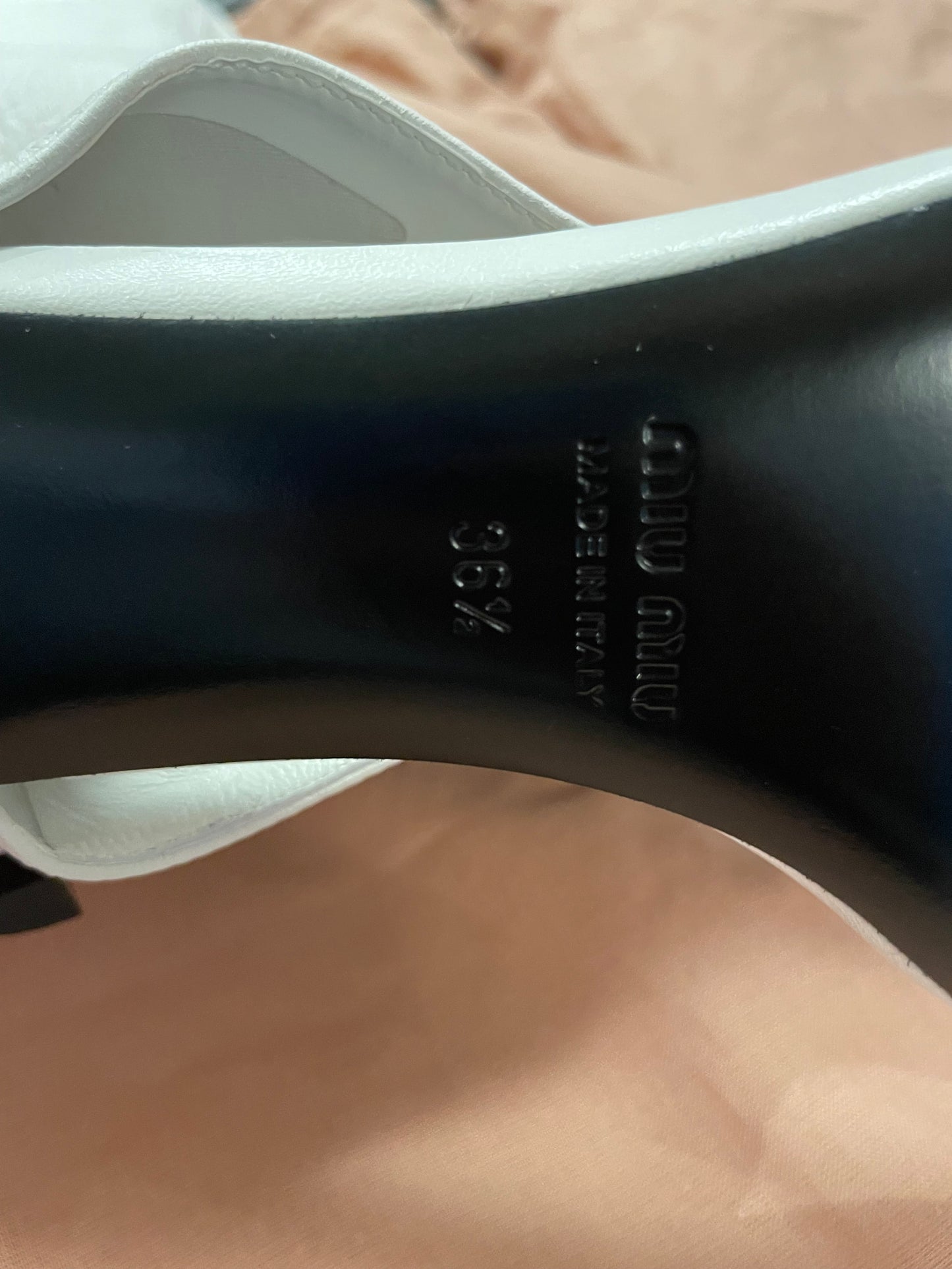 Close-up of a Miu Miu sandal sole with brand name and size 36.5 marking.