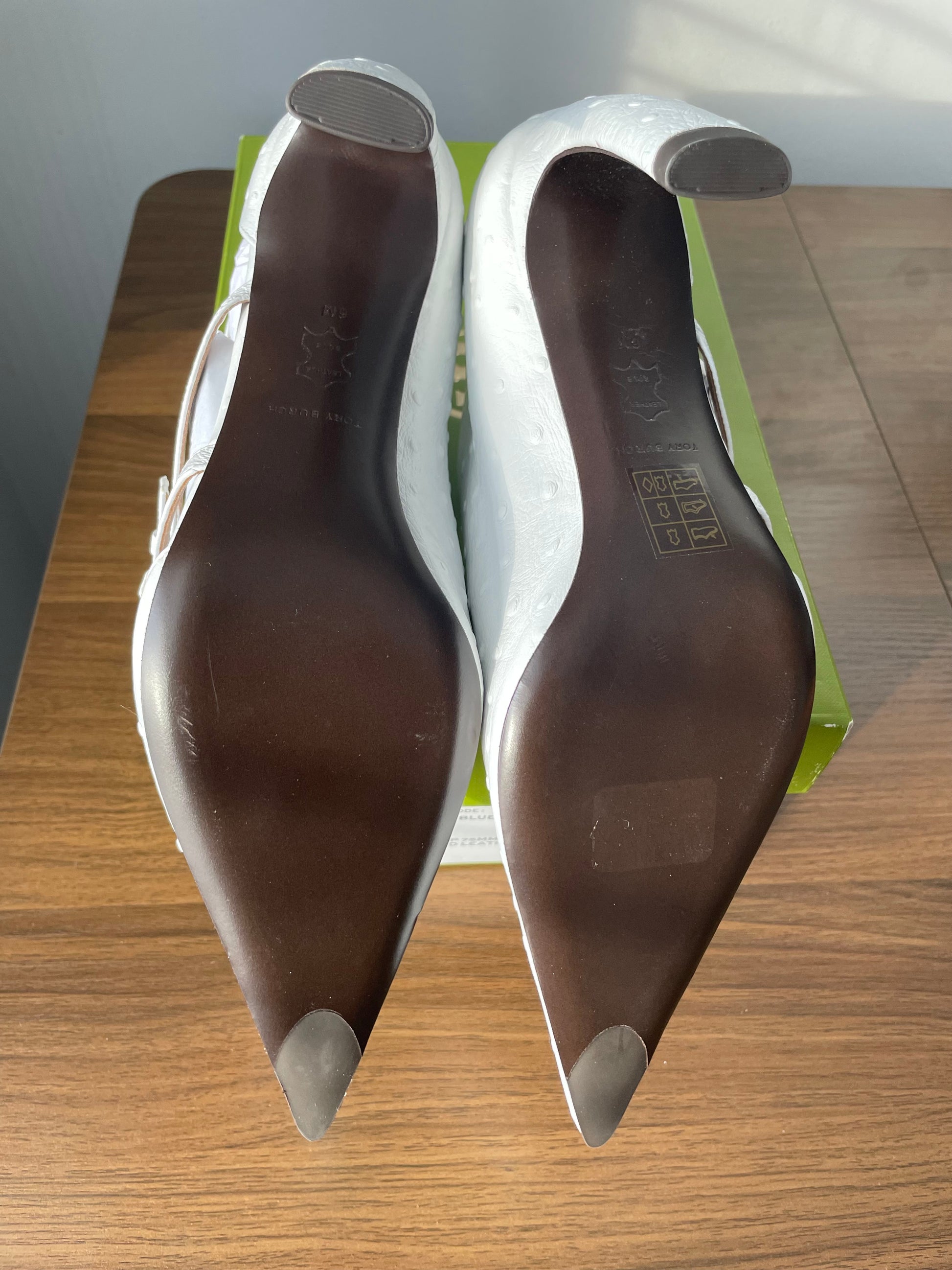 Pair of Tory Burch White Multi-Buckle Pump Showing Bottom of Soles