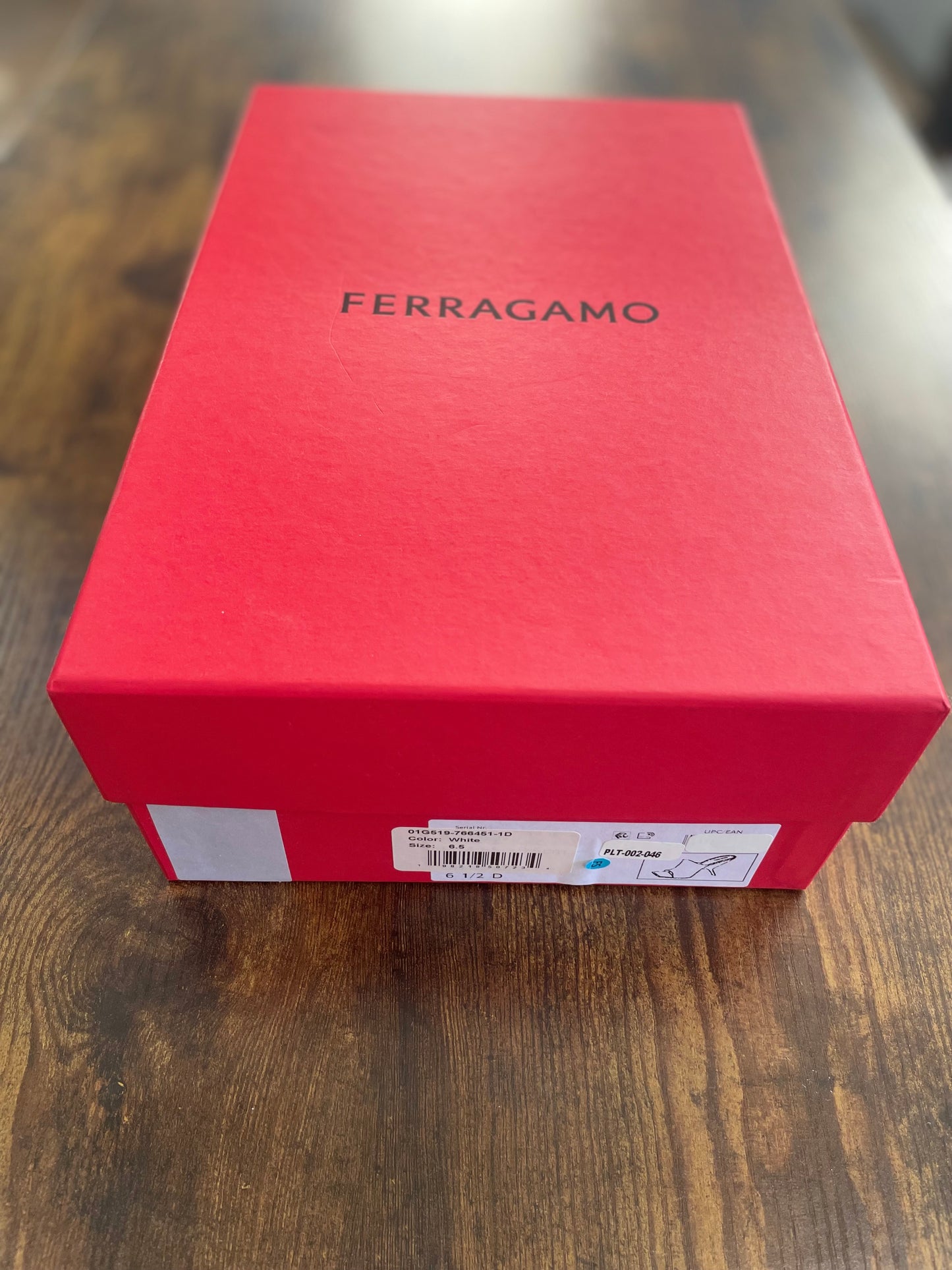 Red Ferragamo box on a wooden surface