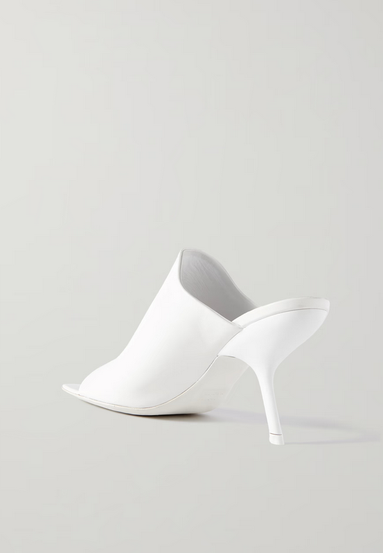 Back view of white square toe Ferragamo shoe on a light gray background