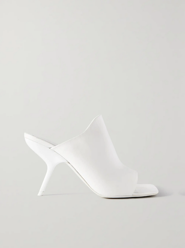 Side view of white square toe Ferragamo shoe on a light gray background