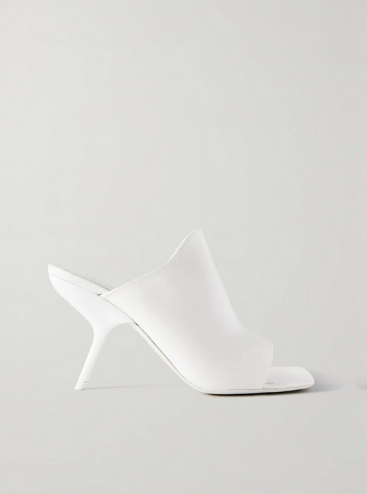 Side view of white square toe Ferragamo shoe on a light gray background