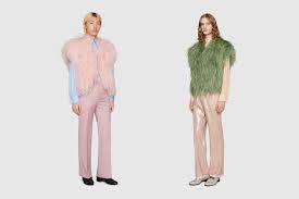 Two male models wearing pink and green Gucci ostrich feather vests